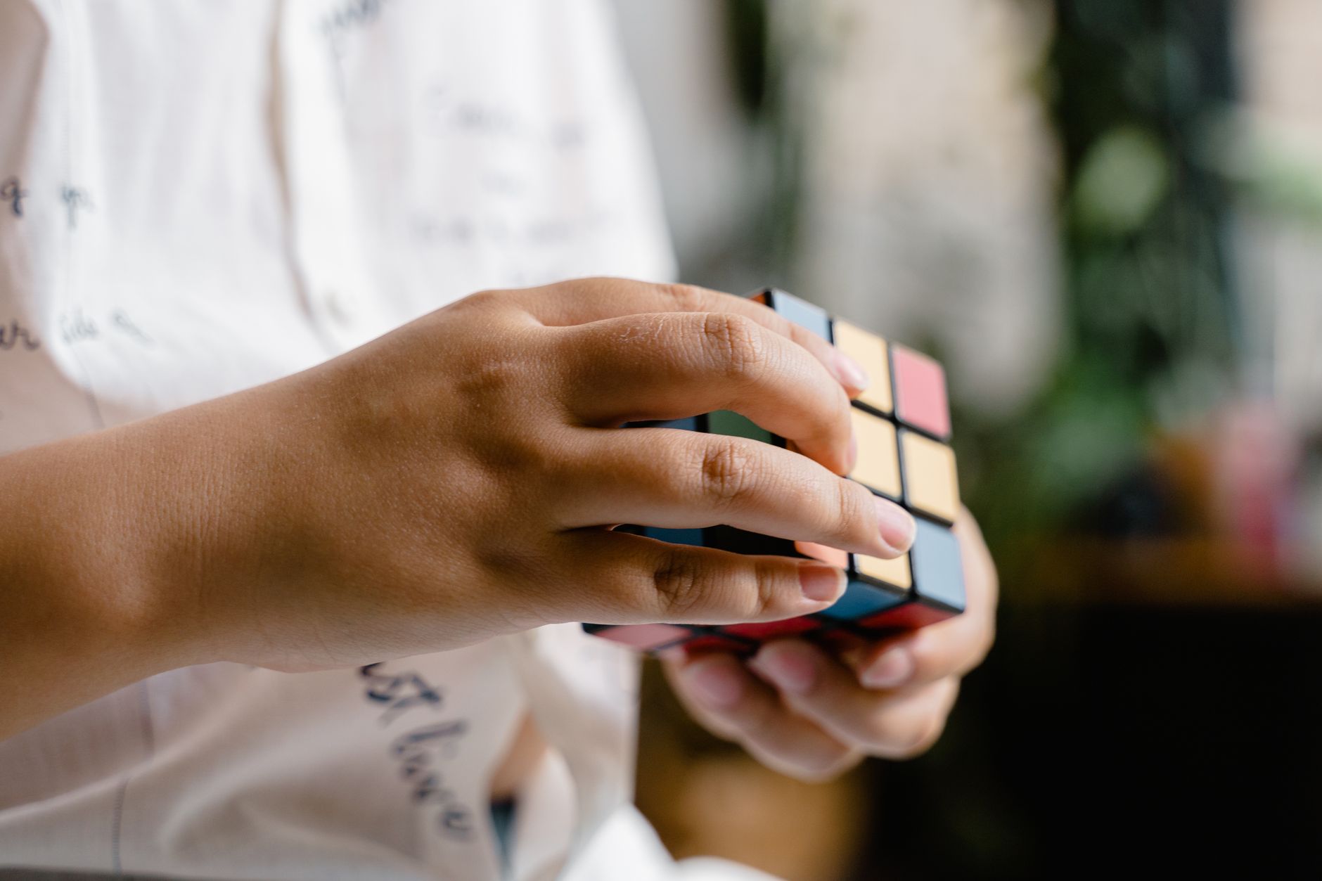 Hands manipulating a Rubik's Cube, showcasing concentration and skill.