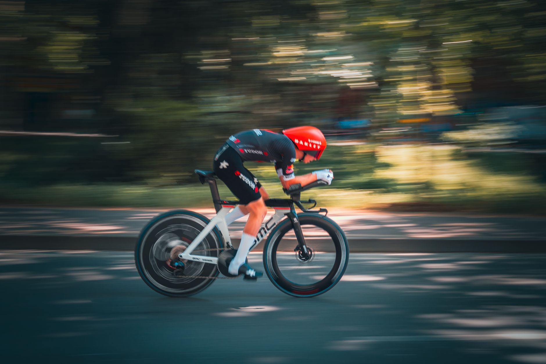 Dynamic shot of a cyclist racing on a sunny day in Tirana, capturing the essence of speed and agility.